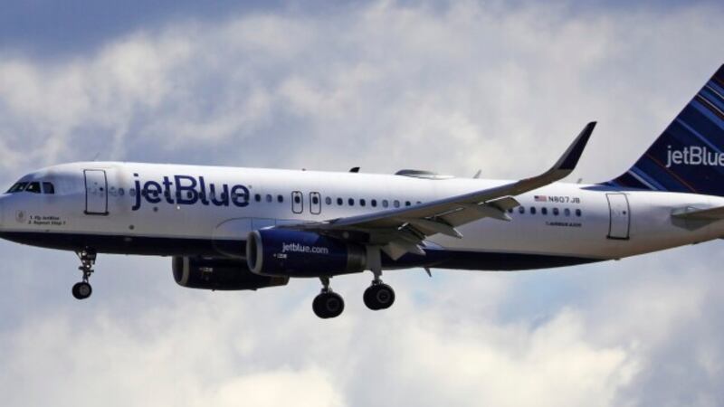 FILE - In this Oct. 18, 2019, file photo a JetBlue Airways flight flies in to Salt Lake City...