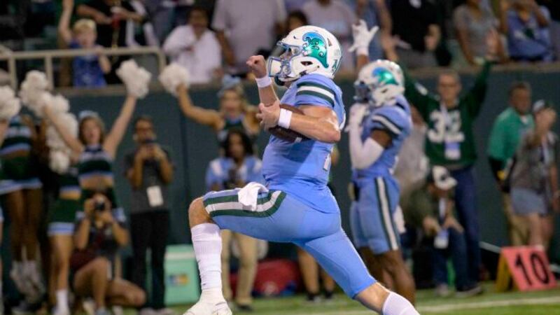 Tulane quarterback Michael Pratt (7) jumps as he scores a touchdown against Central Florida...