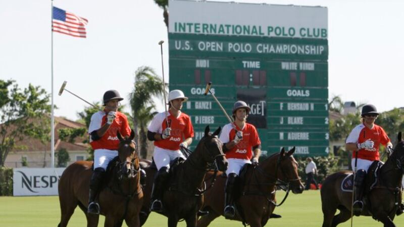 Players on the Audi polo team ride their horses onto the field during the semifinals of the...