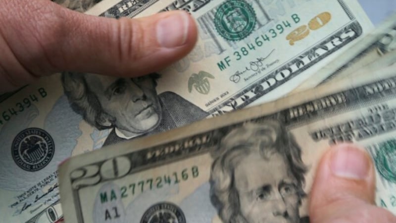 FILE - In this June 15, 2018 file photo, twenty dollar bills are counted in North Andover,...