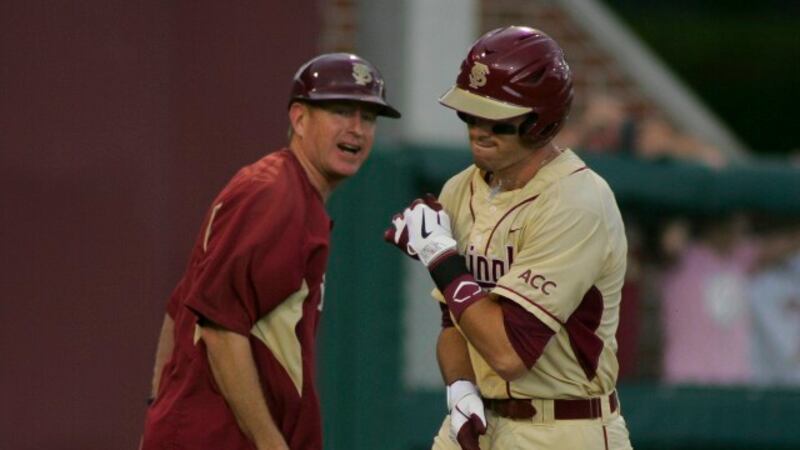 Florida State's Jayce Boyd (right) is congratulated by third base coach MIke Martin, Jr. as he...
