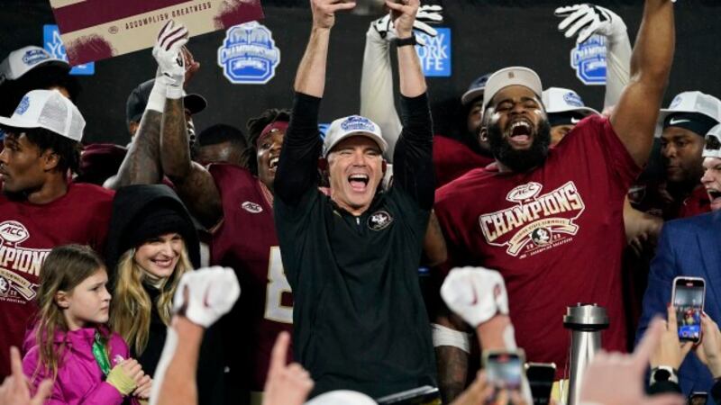 Florida State coach Mike Norvell lifts the trophy after the team's win over Louisville in the...