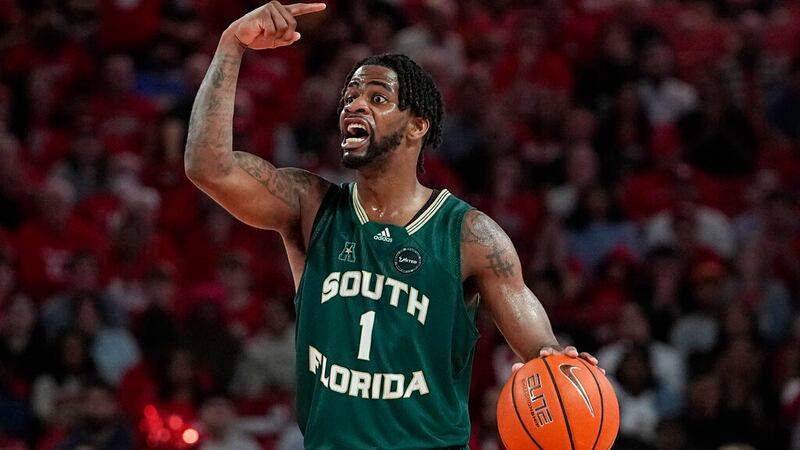 South Florida's Selton Miguel (1) brings the ball up the court against Houston during the...