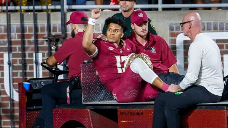 Florida State quarterback Jordan Travis is taken off the field after being injured during the...