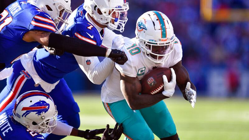 Miami Dolphins wide receiver Tyreek Hill (10), right, tries to break free from the Buffalo...