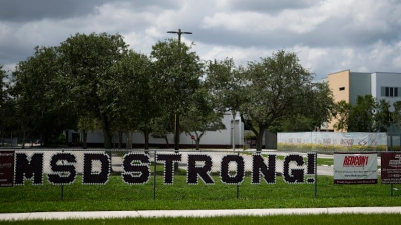 Letters on a fence read "MSD Strong" outside Marjory Stoneman Douglas High School in Parkland,...