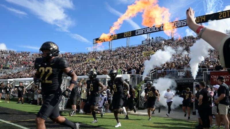 Central Florida players run onto the field before an NCAA college football game against...