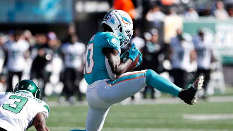 Miami Dolphins wide receiver Tyreek Hill (10) makes a catch in front of New York Jets safety...