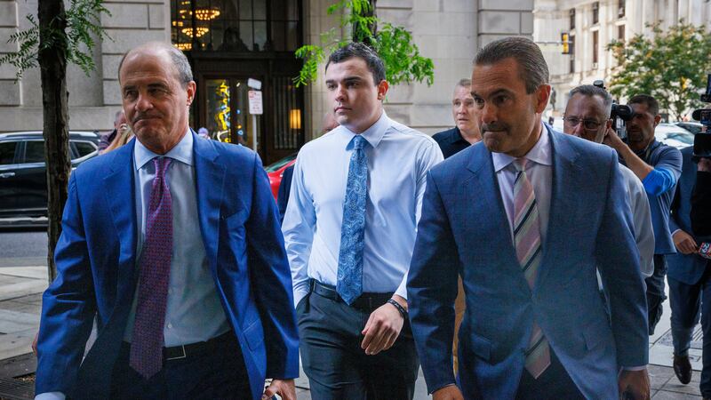 Philadelphia police officer Mark Dial, center, arrives at the Juanita Kidd Stout Center for...
