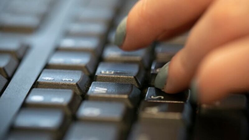 FILE - In this Oct. 8, 2019, file photo a woman types on a keyboard in New York. Phishing...